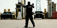 Image: U.S. Customs and Border Protection agents direct vehicles re-entering the U.S. from Canada, which has opened its borders to U.S. citizens who can provide proof of vaccination and a negative Covid-19 test, for random searches and inspections at the Ambassador Bridge Port of Entry Aug. 9, 2021 in Detroit.
