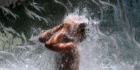 Image: A young boy cools down in a waterfall at Yards Park in Washington on Aug. 12, 2021, as a heat wave hit the region.