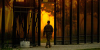A National Guardsman stands guard at a fence that runs along the Rio Grande near the International bridge on Sept. 17, 2021, in Del Rio, Texas.