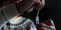 A resident processes a self-administered at-home Covid-19 test in Easton, N.H., on Dec. 7, 2021.