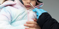 A child receives a Covid-19 test at a Philadelphia Department of Public Health mobile testing site in Philadelphia on Dec. 30, 2021.