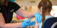A nurse administers a pediatric dose of the Covid-19 vaccine