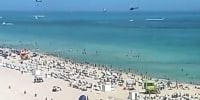 A helicopter crashes into the ocean at Miami Beach