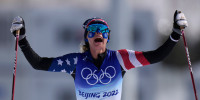 Jessie Diggins celebrates as she crosses the finish in second during the women's 30km mass start free cross-country skiing competition at the 2022 Winter Olympics, Sunday, Feb. 20, 2022, in Zhangjiakou, China.