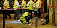 Image: Forensics experts investigate the scene of a shooting in Dizengoff Street in Tel Aviv on April 7, 2022.