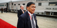 U.S. Transportation Secretary Norman Mineta walks past a train after the grand opening ceremony of the Alameda Corridor railway on April 12, 2002 in Los Angeles.