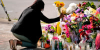 Shannon Waedell-Collins pays her respects at the scene of Saturday's shooting at a supermarket in Buffalo