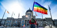Demonstrators gather on the step of the Montana State Capitol protesting anti-LGBTQ+ legislation on March 15, 2021, in Helena, Mont.