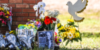 Image: The photo of a little girl, victim of the shooting, is seen by flowers placed on a makeshift memorial in front of Robb Elementary School in Uvalde, Texas, on May 25, 2022.