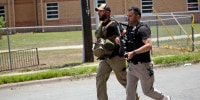 Police outside Robb Elementary School following a shooting, in Uvalde, Texas, on May 24, 2022.