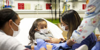 A child receives her second dose of the Moderna COVID-19 vaccine