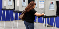 A voter fills out primary ballots at an early voting center in Santa Fe, N.M., on June 1, 2022.