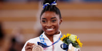 Simone Biles poses with the bronze medal during the Women's Balance Beam Final medal ceremony at the Tokyo 2020 Olympic Games on Aug. 3, 2021.