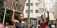 Demonstrators hold "Justice for Jayland" signs outside Akron City Hall