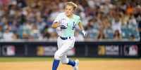 Jojo Siwa gestures runs the bases during the MLB All Star Celebrity Softball game, Saturday, July 16, 2022, in Los Angeles. (AP Photo/Abbie Parr)