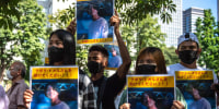 Image: A group of activists hold placards of Japanese citizen Toru Kubota, who is detained in Myanmar, during a rally in front of the Ministry of Foreign Affairs in Tokyo on July 31, 2022.