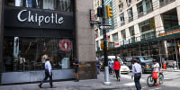 Image: People walk past a Chipotle store on Aug. 10, 2022 in New York.