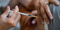 A health care worker administers a dose of Imvanex, a vaccine to protect against monkeypox virus, at a municipal vaccination center in Marseille, France, on Aug. 10, 2022.