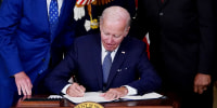 President Joe Biden signs the Inflation Reduction Act of 2022 into law during a ceremony in the State Dining Room of the White House in Washington, D.C. on Tuesday.