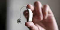 Image: Hand holding hearing aid