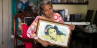 Rosa Hernández holds a picture of her daughter, Rosaura Almonte