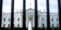 Image: White House seen through a gate.