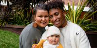 Ellia Green with his partner Vanessa Turnbull-Roberts and their daughter Waitui pose in Sydney, Australia, Monday, Aug. 15, 2022. Green, one of the stars of Australia's gold medal-winning women's rugby sevens team at the 2016 Olympics, has transitioned to male. The 29-year-old, Fiji-born Green is going public in a video at an international summit aimed at ending transphobia and homophobia in sport. The summit is being hosted in Ottawa as part of the Bingham Cup rugby tournament. (AP Photo/Mark Baker)