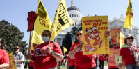 Fast food workers and their supporters march past the state Capitol calling on passage of a bill to provide increased power to fast-food workers in Sacramento, Calif., on Aug. 16, 2022.