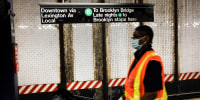 A worker walks along a platform of the New York City subway on June 3, 2021 in New York City.