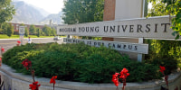 A sign stands at the main entrance to the campus of Brigham