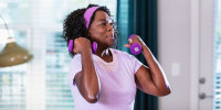 Woman breathing out during bicep curls