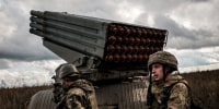 Image: Ukrainian soldiers prepare to fire a BM-21 multiple rocket launcher towards Russian positions in the Kharkiv region on Oct. 4, 2022.