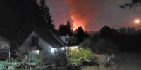 A wildfire burns the Conway family farm in Camas, Wash.