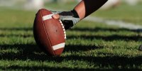 A football player gets ready to hike a football.