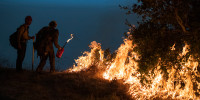 Firefighters light a controlled burn along Nacimiento-Fergusson Road to help contain the Dolan Fire near Big Sur, Calif., on Sept. 11, 2020.