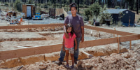 Inez Salinas and her daughter, River, at the site of their new house in Concow, Calif., on Sept. 1, 2022.