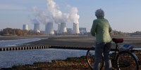 An elderly woman looks at the Jaenschwalde lignite coal-fired power plant, in Peitz, Germany