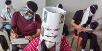 Students at Bicol University College of Engineering in Legazpi City, the Philippines, take an exam on Oct. 17, 2022, while wearing 'anti-cheating hats' they designed as part of an assignment