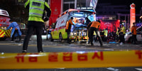 A person gets loaded into an ambulance on the street