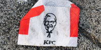 An empty KFC bag for French Fries on a sidewalk in Poland. 