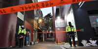 Police stand guard at the cordoned scene of the deadly Halloween crowd surge in Seoul on Nov. 1, 2022. 