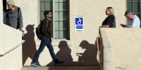 Voters wait to cast their ballots on Nov. 8, 2022 in Tucson, Ariz.