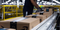 Boxes move along a conveyor belt at an Amazon fulfillment center on Prime Day in Raleigh, N.C.