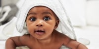 Shot of an adorable baby boy wearing a hoody towel