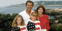 George W., Laura Bush and their daughters Barbara and Jenna wearing matching American flag shirts.