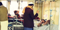 Wounded Afghan men receive treatment at a hospital following a blast at a madrassa in Aybak city of Samangan province on November 30, 2022. - At least 16 people were killed and 24 others wounded November 30 by a blast at a madrassa in Afghanistan's northern city of Aybak, a doctor at a local hospital told AFP. 
