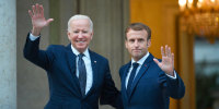 French President Emmanuel Macron welcomes US President Joe Biden (L) before their meeting at the French Embassy to the Vatican in Rome on October 29, 2021.