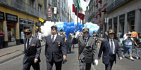 Former members of Mexican Air Force 201 squadron march in a parade