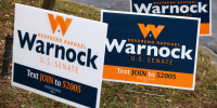 Campaign signs for Sen. Raphael Warnock