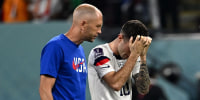 Christian Pulisic of the United States reacts next to Head Coach Gregg Berhalter after losing the World Cup